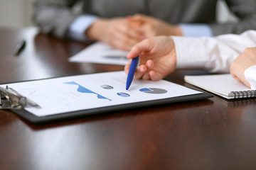 Close up  of unknown  business people at meeting discussing financial results