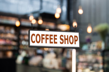Coffee shop signboard with coffee shop blurred background