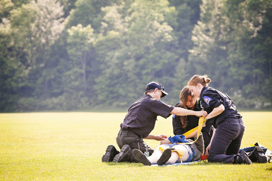 Paramedics assisting patient