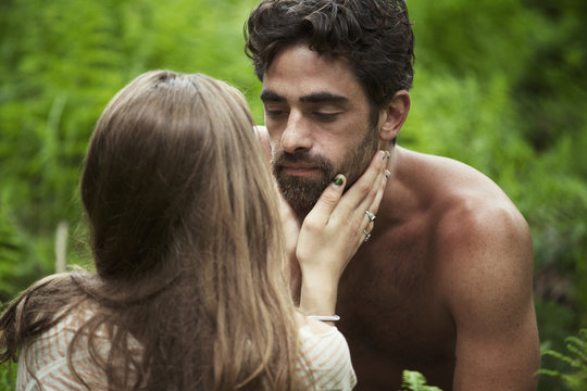 Passionate couple face to face in forest