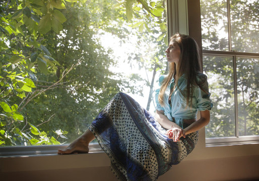 Woman looking through window