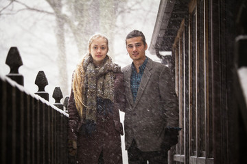 Portrait of young couple on deck in snow