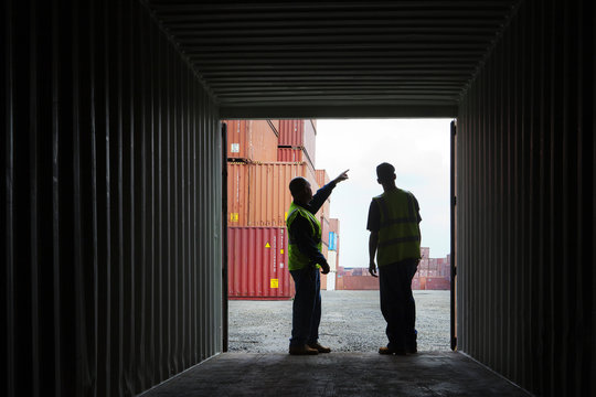 Worker talking with each other at cargo warehouse