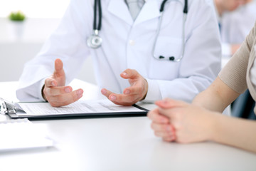 Fototapeta premium Doctor and patient are discussing something, just hands at the table