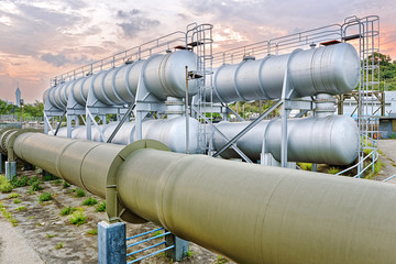 Oil and gas industry refinery factory at sunset