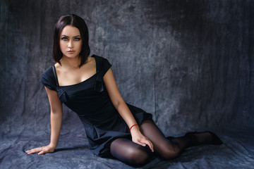 Beautiful girl in a sexy black dress
