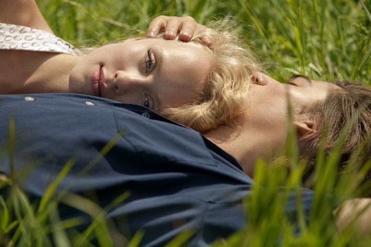 Young couple resting in meadow