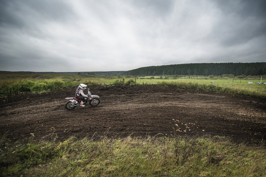 Man motocross riding on dirt road