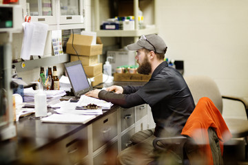 Brewery worker using computer