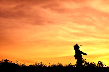 Fototapeta na wymiar Silhouette little girl at sunset