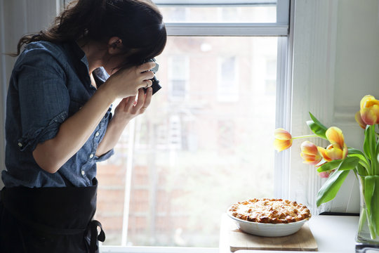 Woman taking picture of baked pie