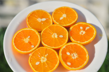 Top view of fresh sliced orange close-up on plate