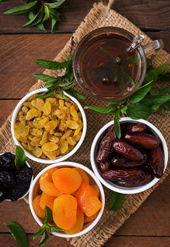 Mix dried fruits (date palm fruits, prunes, dried apricots, raisins) and nuts, and traditional Arabic tea. Ramadan (Ramazan) food. Top view