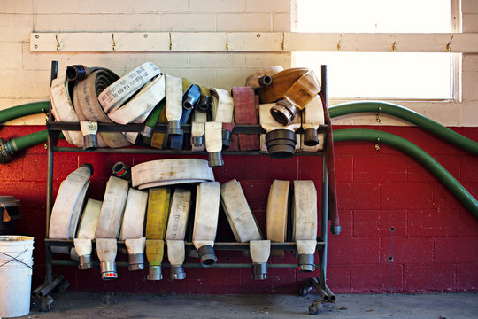 Fire hose and pipes on rack at fire station