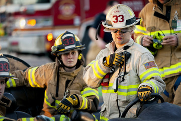 Firefighter talking on two way radio outdoors