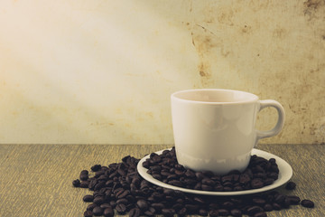 Coffee cup and beans on wooden