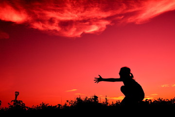 Silhouette sad girl at sunset.
