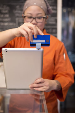 Woman swiping card trough reader