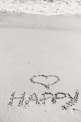 Happy Love heart sign on sandy beach outdoors