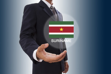 Businessman hand showing Suriname Flag 