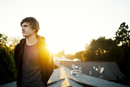 Man on roof at sunset