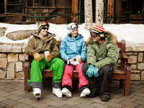 Three friends taking break from skiing
