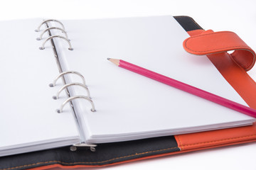 image of a notebooks and pencil on white background, close-up