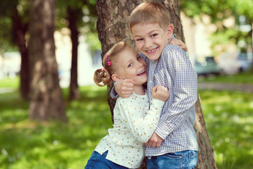 Fototapeta na wymiar Portrait of two happy cute kids summer park