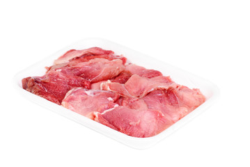 plastic pack of raw meat slices  isolated on the white background