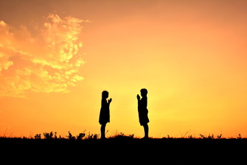 Silhouette children at sky sunset
