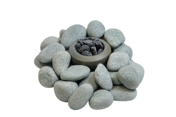 Pile of smooth stones around the stone bowl with stones. Objects on a white background.