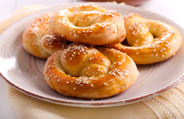 Soft pretzels with sesame seeds on plate