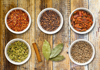 Spices in Pots on a Distressed Wooden Board