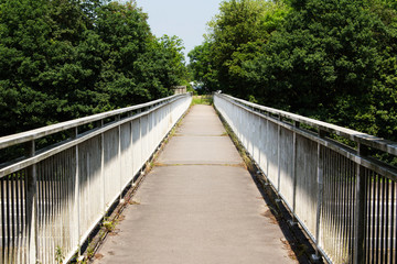 View along a long footbridge with railings on either side