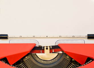close up image of red typewriter with paper sheet. copy space for your text. retro filtered