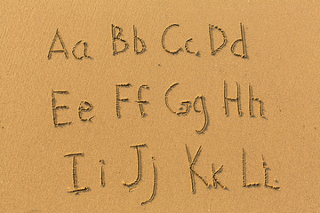 Alphabet letters drawn on beach sand (A-L, 1/2)