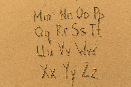 Alphabet letters drawn on beach sand (M-Z, 2/2)