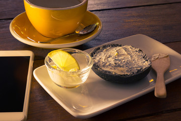 Charcoal bagel with spreaded cream cheese