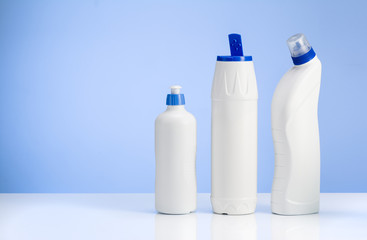 Cleaning concept background. Assorted products isolated on white and blue backdrop. Studio product shot for advertising, website or blog.