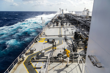 Big grey oil tanker underway in the open sea.