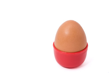 Egg in red cup isolated on white background