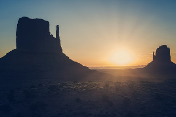View of West and East Mitten Buttes in monument valley during sunset