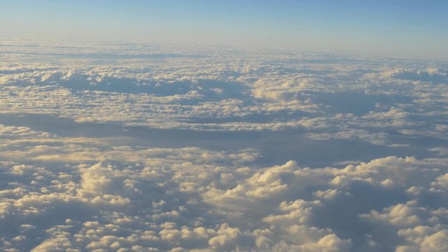 traveling by air. View through airplane window. Flight abobe spectacluar clouds. 4k