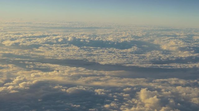 traveling by air. View through airplane window. Flight abobe spectacluar clouds. 4k