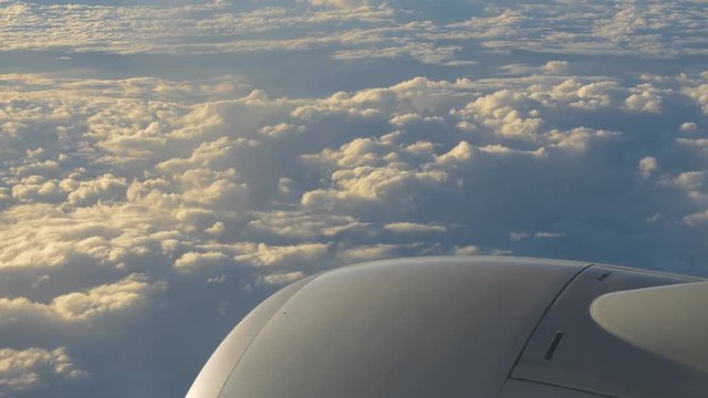traveling by air. View through airplane window. Flight abobe spectacluar clouds. 4k