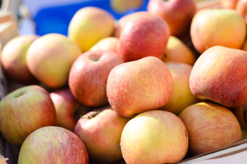 Fresh organic apples on sunny background