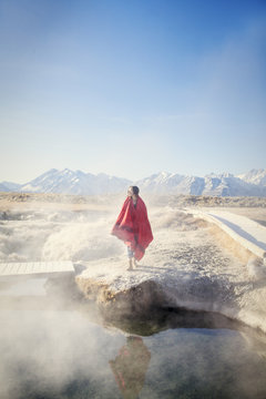 Woman looking at view while standing near hot spring