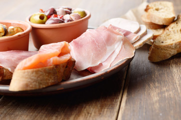 Tapas of salmon, mussels, jamon and olives