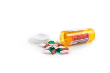 Mixed pills with medicine bottle.