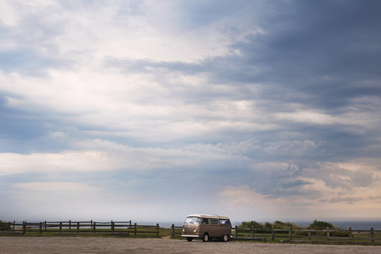 Volkswagen Transporter T2 in parking lot under moody sky